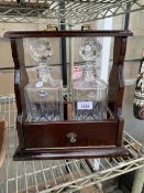A WOODEN TWO BOTTLE TANTALUS WITH TWO EDINBURGH CRYSTAL DECANTERS AND KEY
