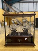 A VINTAGE LOCKING TANTALUS WITH CUT CRYSTAL DECANTERS BY THOMAS WEBB PLUS TWO METAL SPIRIT LABELS