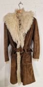 A vintage suede Afghan coat with a fur trim shawl collar, belt and sheepskin lining. Label: Elma