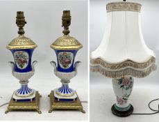 A pair of small vintage ceramic table lamps with hand painted floral detail and gilt metal bases