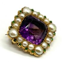 A Victorian 15ct gold (tested) amethyst brooch with a surround of pearls and demantoid garnet