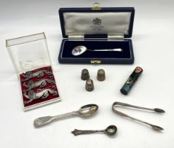 A collection of silver including spoons, sugar nips, set of three Estonian silver lions etc, along