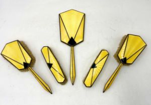 A silver plated Art Deco yellow enamelled dressing table set with black geometric detail