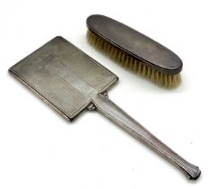 A silver Art Deco dressing table mirror and brush