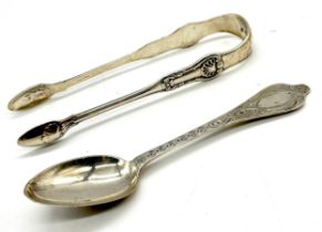 A hallmarked silver pair of sugar tongs (Glasgow 1823) along with a silver spoon (Newcastle 1867,