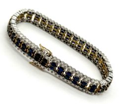 A 9ct two colour gold diamond and sapphire bracelet - length 18.5cm, total weight 26.89g