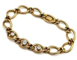 An 18ct gold curb bracelet set with three with diamonds, the central stone of approximately 0.75ct -