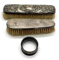 Two hallmarked silver backed brushes along with a silver serviette ring