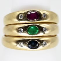 3 different band rings, each set with sapphire, ruby and emerald and flanked on each side by 1 bril