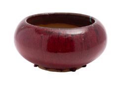 A Chinese stoneware flambé glazed bowl of squat circular form, 29cm diameter.