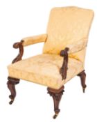 An early Victorian carved walnut and later Damask fabric upholstered library armchair,