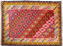 A Qashgai Kelim, the rose field with a diagonal design of geometric medallions,