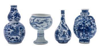 Three Chinese porcelain vases and a stem cup each painted in blue,