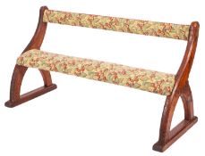 A pair of Victorian pine and upholstered settles in reformed Gothic style,