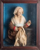 A pair of scarce Continental decorated wax models of an elderly man and woman,