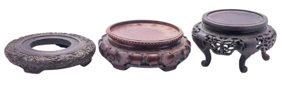 A large Chinese hardwood 'dragon' stand and two others,