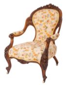 A Victorian carved walnut and upholstered armchair,