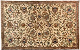 A Tabriz carpet, the ivory field with an all over design of palmettes and scrolling floral foliage,