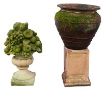 A terracotta urn with associated composition plinth, 20th century; the ovoid urn 39cm high,