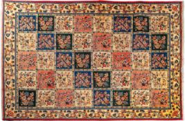 A Sarouk carpet, the compartmented field in ivory, rose,