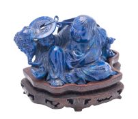 A Chinese carved lapis lazuli figure of Liu Hai, late 20th century seated with his money-toad,