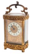 An Edwardian Serpentine shaped French carriage clock timepiece the unmarked eight-day duration