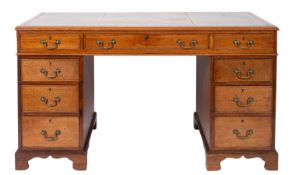 A mahogany and leather inset pedestal desk in George III style,