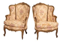 A pair of carved and giltwood and upholstered canapé chairs in late Louis XV taste,