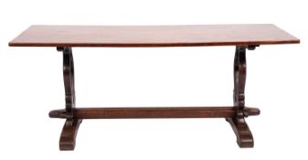 An oak trestle table in Arts & Crafts style,