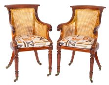 A pair of Regency mahogany and canework library bergeres,