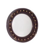 A circular stained wood framed convex wall mirror in Regency style,