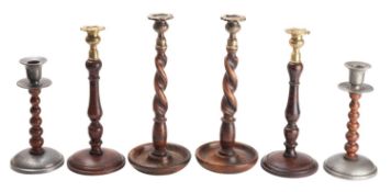 Three pairs of metal mounted stained wood candlestick,