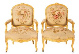 A pair of carved and giltwood fauteuil salon chairs in Louis XV style,
