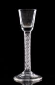 An English cordial glass the rounded funnel shaped bowl set on a straight mercury twist stem on a