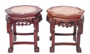 A matched pair of Chinese stained hardwood and polished stone inset stands,