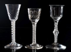 Three English opaque twist wine glasses one with round funnel bowl engraved Thos.