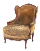 A Continental walnut and upholstered wing armchair in mid 18th century taste,