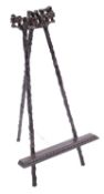 A Chinese hardwood easel, the legs and crest carved with flowering prunus, 48cm high.