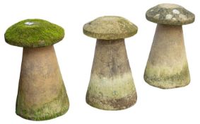 A set of three stone composition staddles with caps,