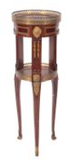 A mahogany and gilt metal mounted etagere, early 20th Century; of circular section,