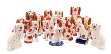 Thirteen Staffordshire and other similar dogs and two cats each painted with liver patches,