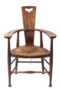 An ash, oak and rush seated elbow chair in Arts & Crafts style,