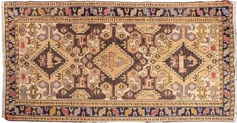 A Sumak Kelim, the beige field with triple hooked lozenge medallions,