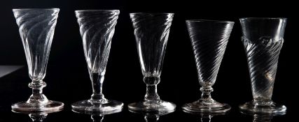 Five English dwarf ale glasses each with wrythen moulded trumpet shaped bowl,