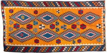 A Qashgai Kelim, the orange field with a design of stepped lozenges and segmented hexagons,