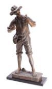 A Continental spelter model of a fisher boy, circa 1900; portrayed standing in loose garb,