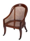 A Regency mahogany and canework library bergere chair,