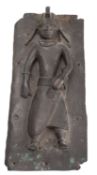 A copper alloy figural relief panel in the style of 16th century Benin examples of West Africa,