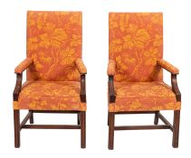 A pair of mahogany and upholstered Gainsborough style armchairs in George III style,
