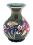 A Walter Moorcroft pottery vase, tube lined in the Orchid pattern,